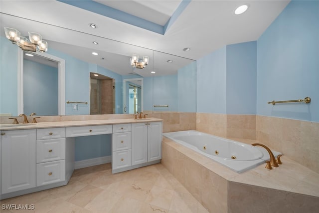 bathroom with vanity and tiled tub