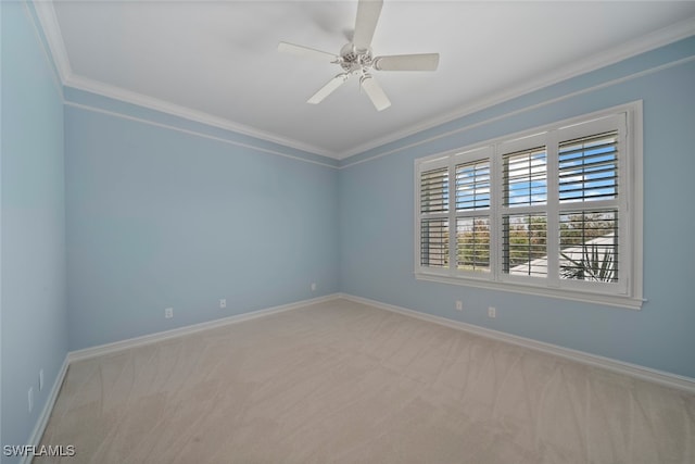 spare room with light colored carpet, ceiling fan, and crown molding