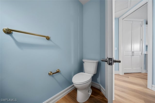 bathroom with wood-type flooring and toilet