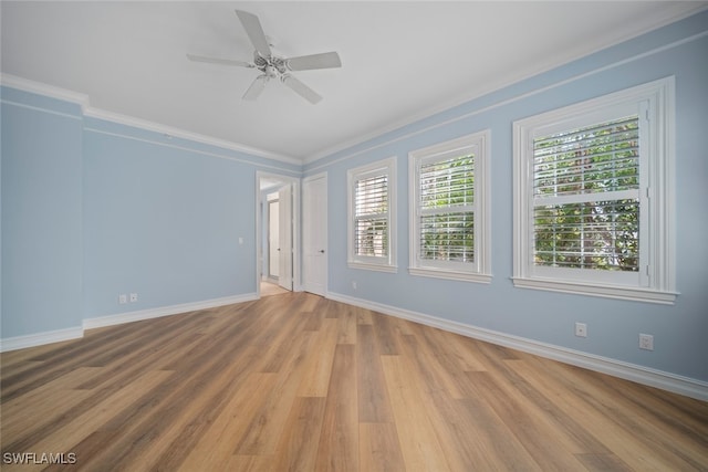 empty room featuring light hardwood / wood-style flooring, ceiling fan, and crown molding