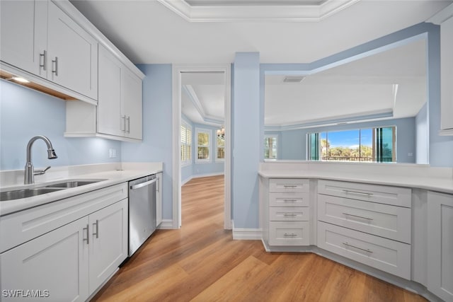 kitchen featuring crown molding, sink, dishwasher, light hardwood / wood-style floors, and white cabinetry