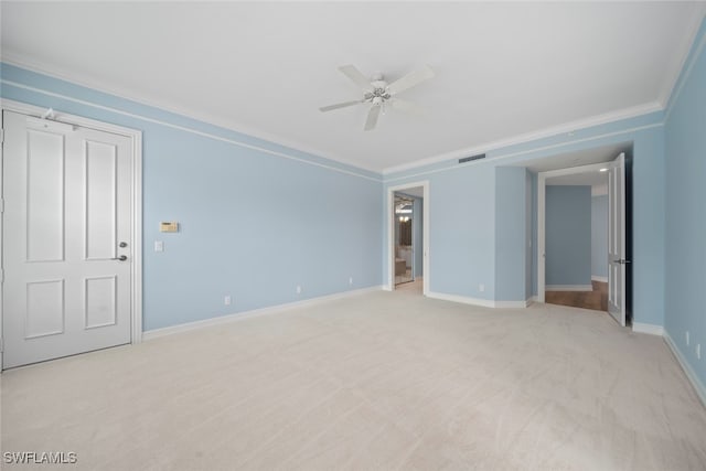 unfurnished room featuring light colored carpet, ceiling fan, and ornamental molding