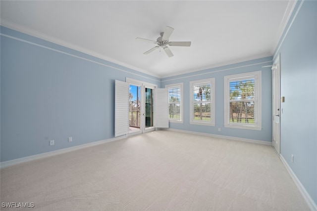 carpeted empty room with ceiling fan and crown molding