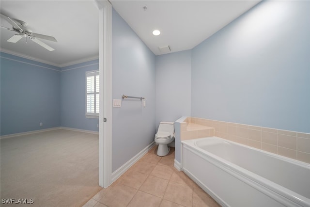 bathroom featuring a tub to relax in, ceiling fan, crown molding, tile patterned flooring, and toilet