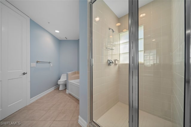 bathroom with toilet, shower with separate bathtub, and tile patterned floors