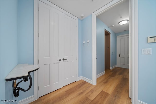 hallway with light wood-type flooring