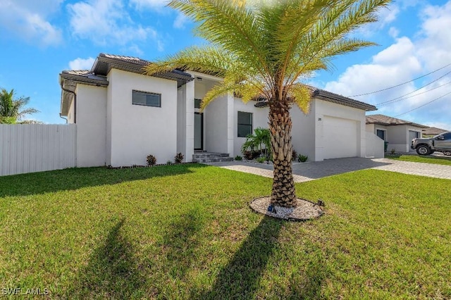 view of front of house featuring a front yard and a garage