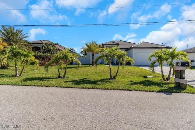 view of front facade with a garage and a front lawn