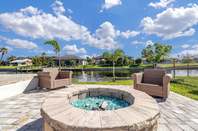 view of pool with a water view, a fire pit, and a patio area