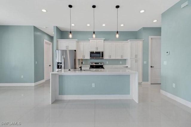 kitchen with a large island with sink, stainless steel appliances, white cabinetry, and hanging light fixtures