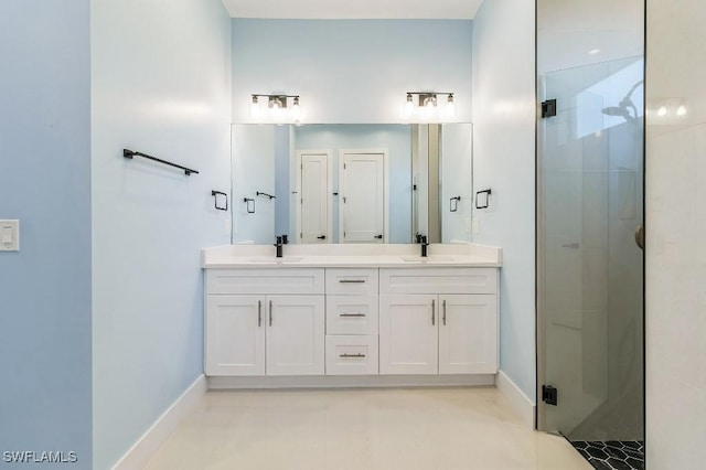 bathroom featuring vanity and a shower with door