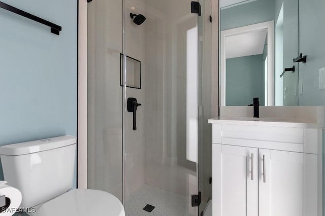 bathroom with toilet, vanity, and walk in shower