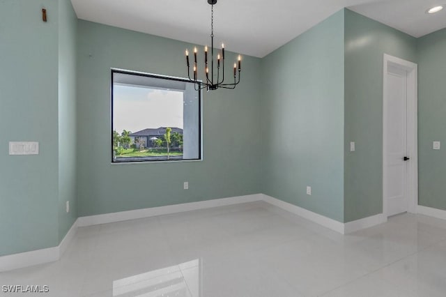 unfurnished room with an inviting chandelier and light tile patterned flooring