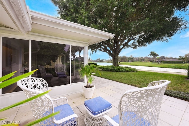 view of patio / terrace featuring a sunroom