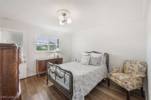 bedroom featuring crown molding, dark wood-type flooring, and a chandelier