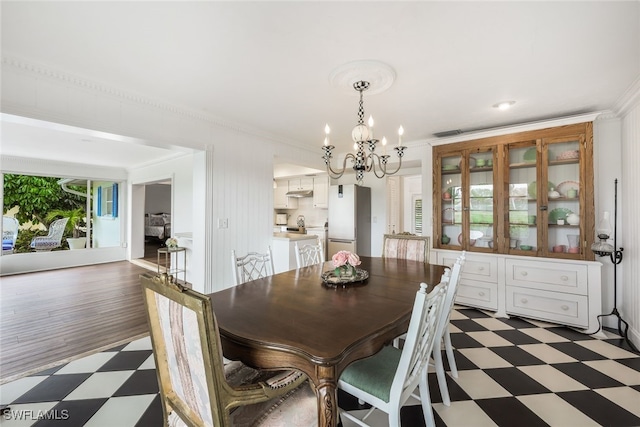 dining area featuring ornamental molding, dark hardwood / wood-style floors, and an inviting chandelier