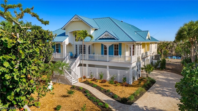 view of front of house with a garage, central AC, and covered porch