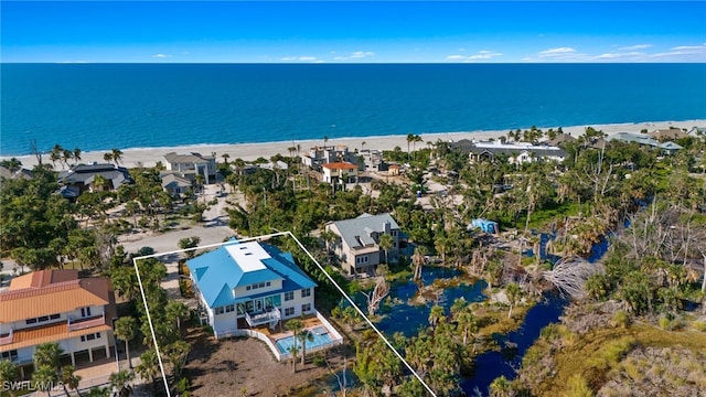 birds eye view of property with a beach view and a water view