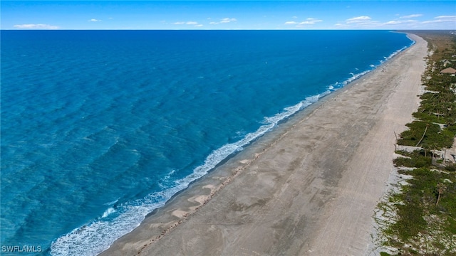 exterior space featuring a beach view and a water view