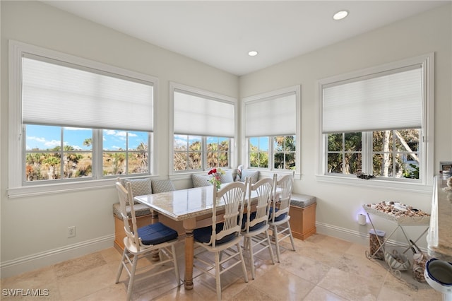 dining space featuring light tile patterned floors, a wealth of natural light, and breakfast area