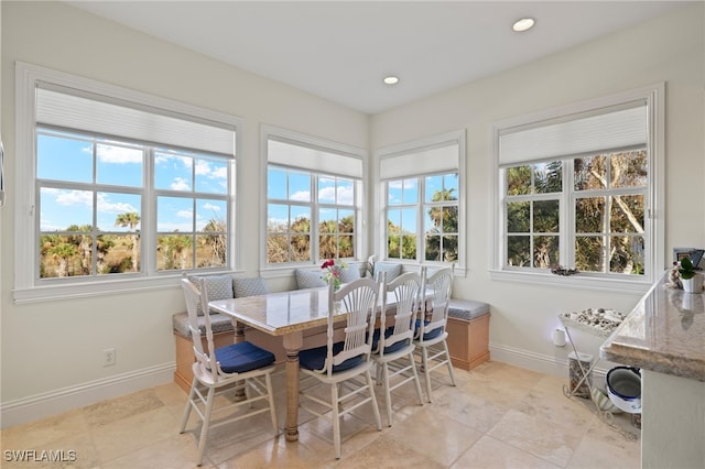 sunroom featuring breakfast area and plenty of natural light