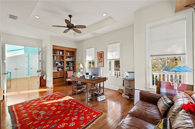 office area featuring plenty of natural light and a tray ceiling