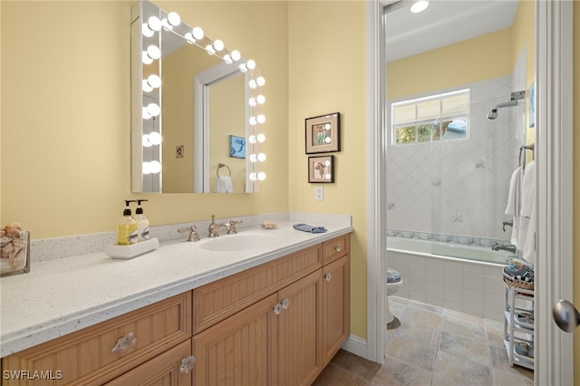 full bathroom featuring toilet, tiled shower / bath combo, and vanity