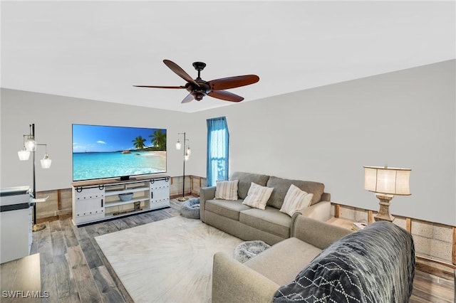 living room featuring ceiling fan and wood-type flooring