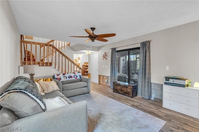 living room with light wood-type flooring and ceiling fan