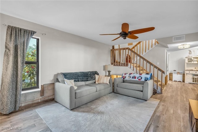 living room with a healthy amount of sunlight, ceiling fan, and wood-type flooring