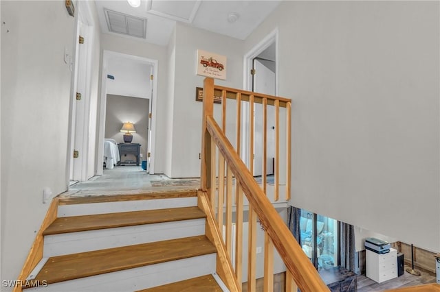 stairway featuring hardwood / wood-style floors