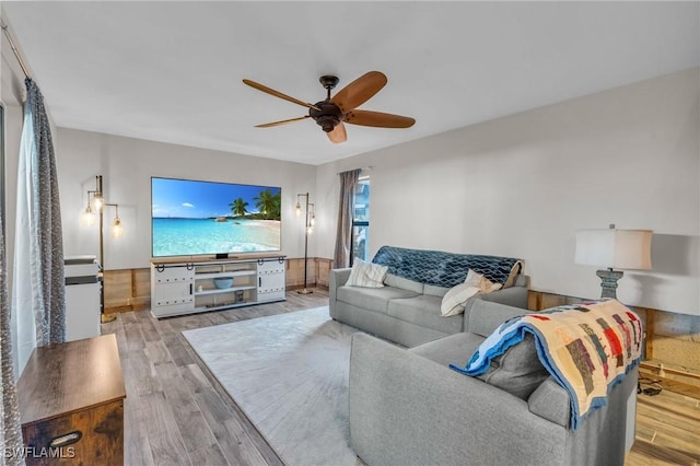 living room featuring light hardwood / wood-style floors and ceiling fan