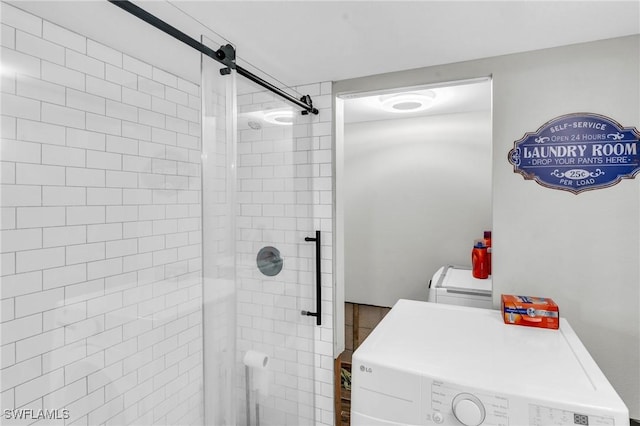 bathroom featuring washer and dryer and walk in shower