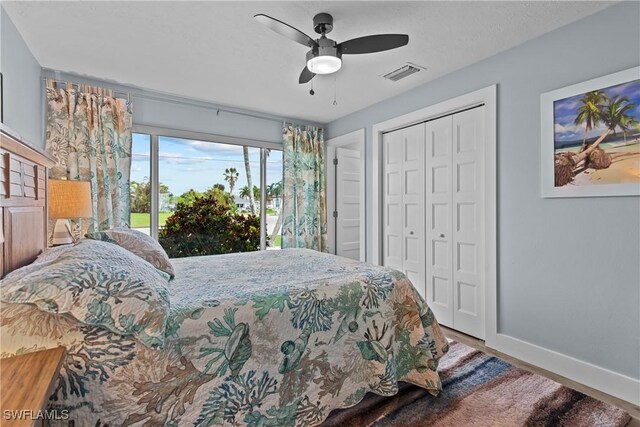 bedroom with ceiling fan, wood-type flooring, and a closet