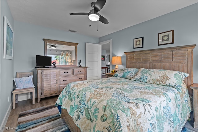 bedroom with ceiling fan and dark hardwood / wood-style floors