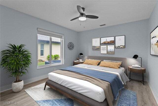 bedroom with light hardwood / wood-style flooring and ceiling fan