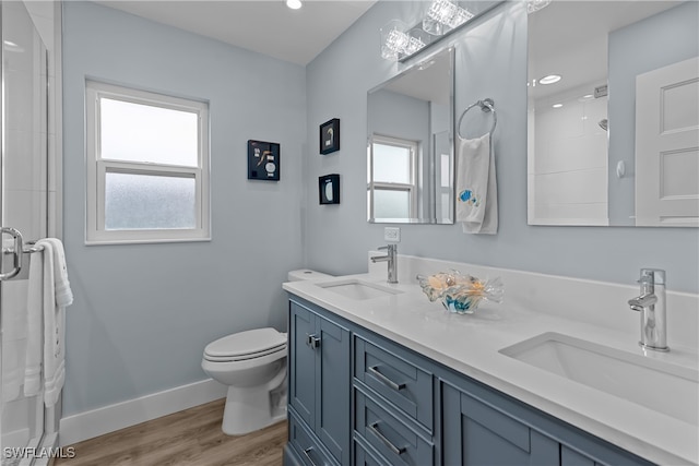 bathroom featuring walk in shower, hardwood / wood-style flooring, toilet, and plenty of natural light