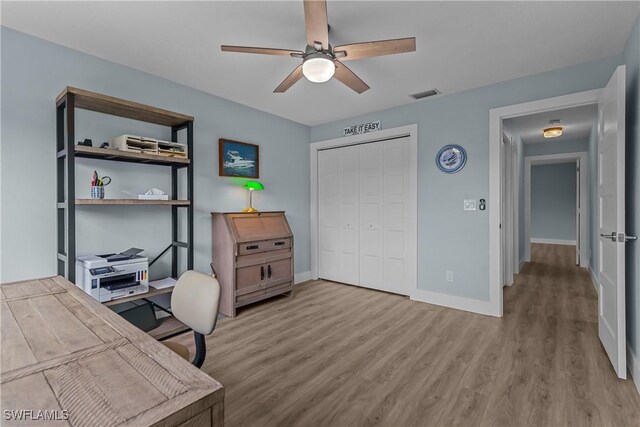 office area featuring light hardwood / wood-style flooring and ceiling fan