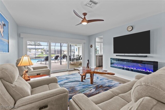 living room with hardwood / wood-style flooring and ceiling fan