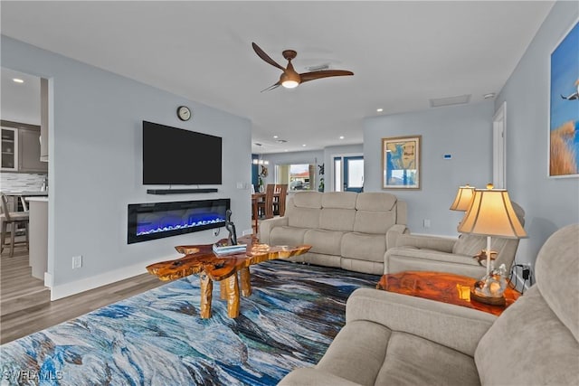 living area with visible vents, a ceiling fan, wood finished floors, and recessed lighting