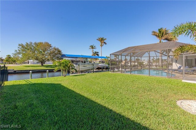 view of yard with a water view and a lanai