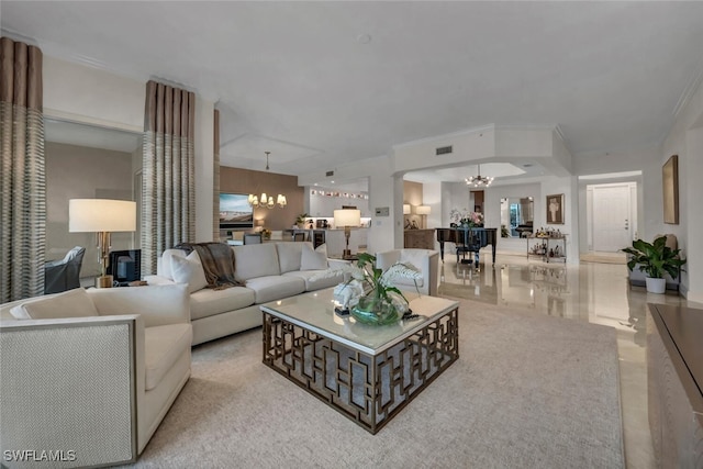 living room with crown molding and a chandelier