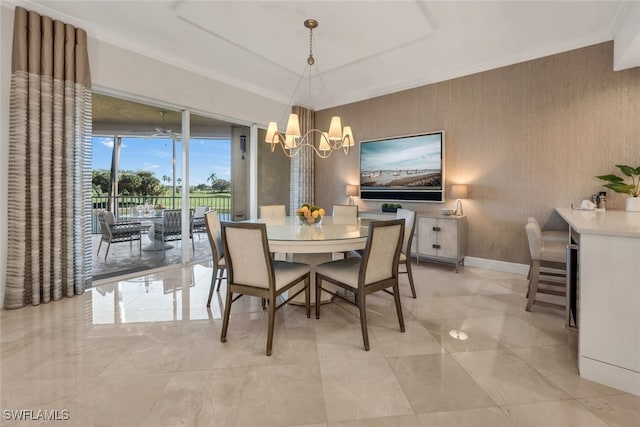 dining area featuring crown molding and an inviting chandelier