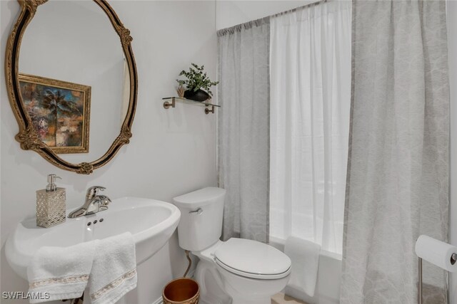 bathroom with shower / bath combo and toilet