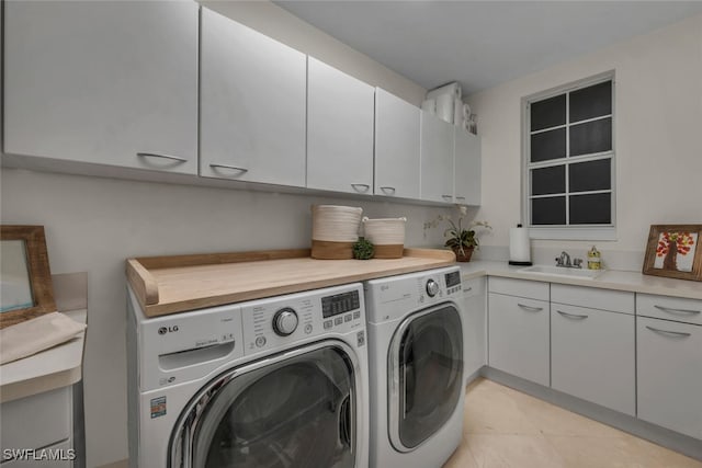 clothes washing area with cabinets, separate washer and dryer, sink, and light tile patterned floors