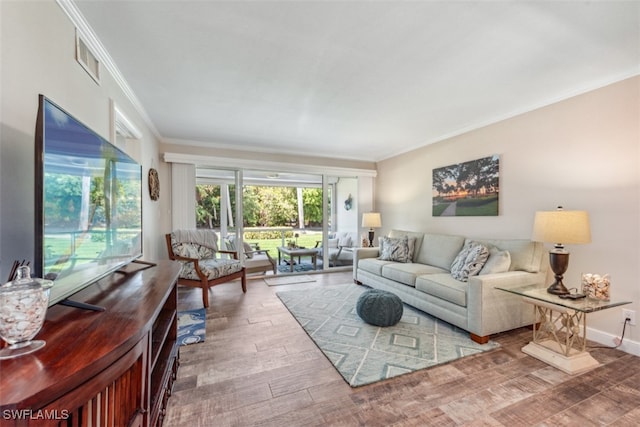 living room with wood-type flooring and ornamental molding