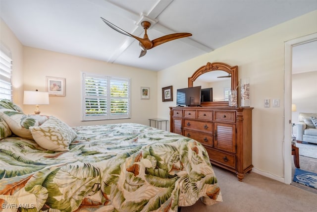 carpeted bedroom featuring ceiling fan, beam ceiling, and multiple windows