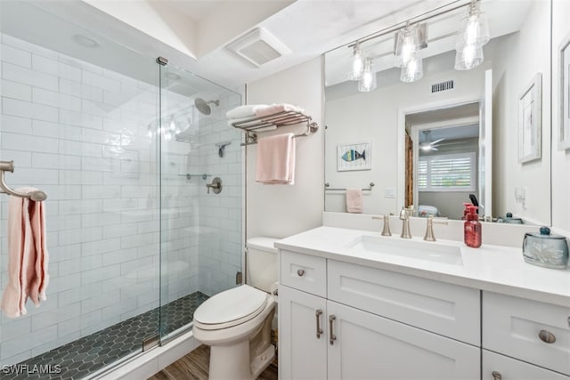 bathroom with a shower with door, hardwood / wood-style flooring, toilet, and vanity