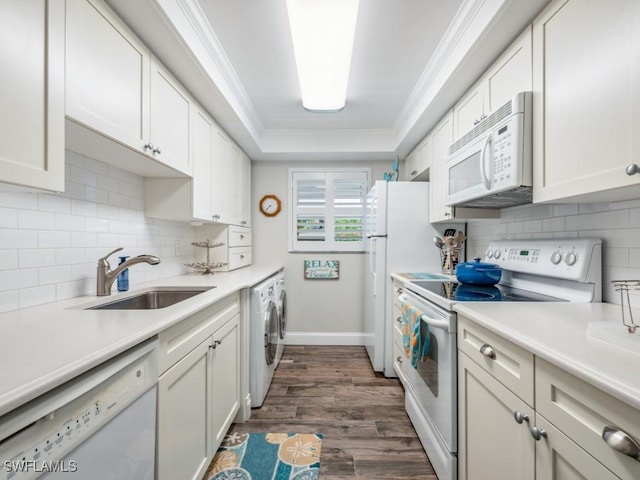 kitchen with white cabinetry, sink, dark hardwood / wood-style flooring, and white appliances