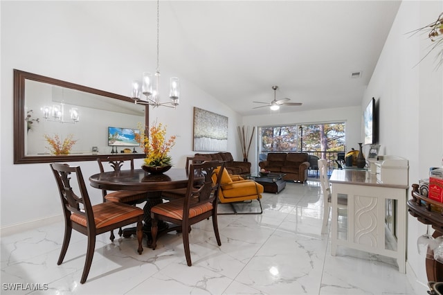 dining room with ceiling fan with notable chandelier and lofted ceiling